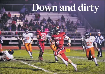  ??  ?? Robertson’s Arjay Ortiz sprints past Taos defenders Friday during their matchup in Las Vegas, N.M.