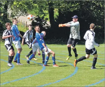  ?? 01_B20footy04 ?? The Brodick keeper punches the ball after a Lamlash attempt at goal.