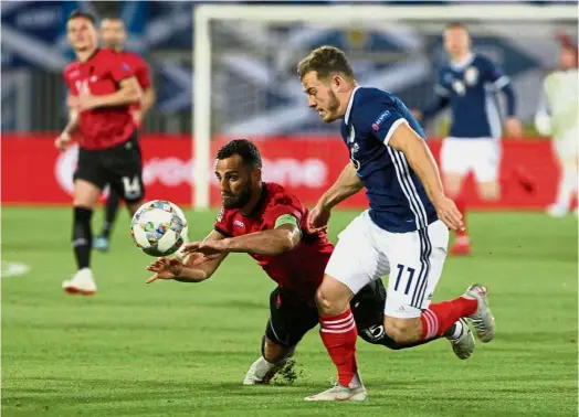  ?? — Reuters ?? A rugby try?: Albania’s Mergrim Mavraj (left) falls from a challenge by Scotland’s Ryan Fraser in the UEFA Nations League match at the Loro Borici Stadium in Albania on Saturday.