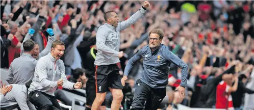 ?? Photo: Evening Standard ?? Liverpool manager Jurgen Klopp (right) celebrates with his players and coaching staff early this year after one of their Premier League victories. Liverpool are now crowned the England champions.