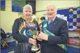  ?? Glavin) (Photo: Katie ?? Anna O’Connor of Fermoy Street Arts and John Murphy, Grand Marshal of the 2023 Fermoy St Patrick’s Day parade, pictured with the trophy for the ‘Best Overall’ entry which was presented to Clondulane on Tuesday.
