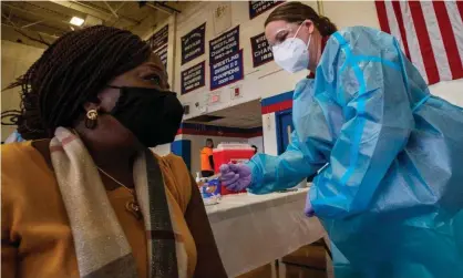  ?? Photograph: Joseph Prezioso/AFP/Getty Images ?? Doris Norman is inoculated with the Moderna Covid-19 vaccine by nurse practition­er Suzanne Wallace in Central Falls, Rhode Island, on 13 February 2021.