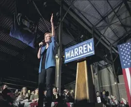  ?? SETH HERALD AFP/Getty Images ?? ELIZABETH WARREN finished third in her home state of Massachuse­tts and won only a few delegates Tuesday, but at a Detroit rally she vowed to push on.