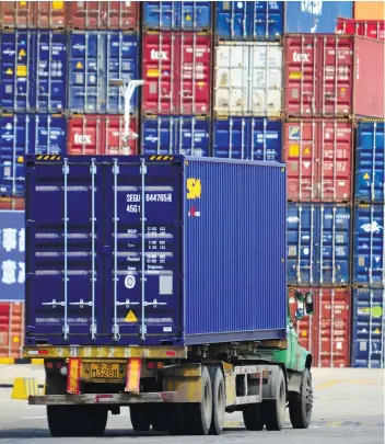  ?? AP FOTO ?? COUNTER POINT. A truck transports a shipping container at the cargo terminal port in Qingdao in east China’s Shandong province on April 6, 2018. China vowed on Friday to fight the US “at any cost” after President Donald Trump proposed slapping an...