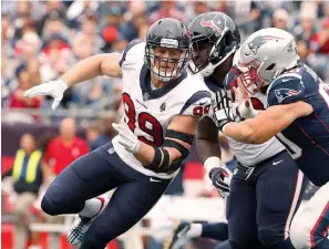  ?? Winslow Townson/AP Images for Panini ?? ■ Houston Texans’ J.J. Watt rushes against the New England Patriots on Sunday at Gillette Stadium in Foxborough, Mass. Watt got better as the day went on his first game back since breaking his leg in October. After getting through that game, the three-time Defensive Player of the Year is looking to make more of an impact this week when the Texans visit Tennessee.