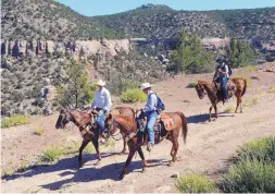  ?? JIM THOMPSON/JOURNAL ?? Interior Secretary Ryan Zinke, left, rides next to U.S. Sen. Tom Udall, D-N.M., in the Sabinoso Wilderness on July 29.