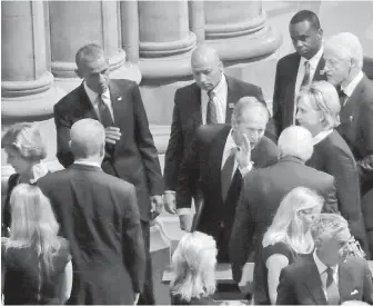  ??  ?? Former U.S. president George W. Bush, centre, leans in to talk to former vice-president Dick Cheney, as he walks out with, from left, former first lady Laura Bush, former president Barack Obama, former secretary of state Hillary Clinton and former president Bill Clinton, after attending the memorial service for Sen. John McCain at Washington National Cathedral on Saturday.