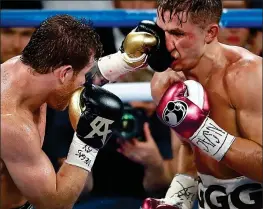  ?? AP ?? On the attack: Canelo Alvarez lands a punch on Golovkin