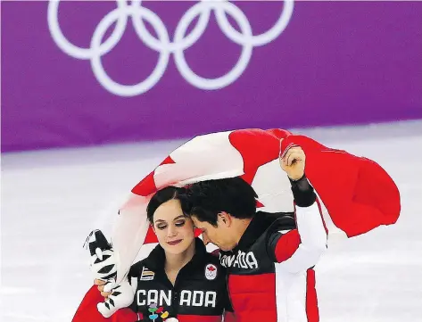  ?? LEAH HENNEL ?? Tessa Virtue and Scott Moir celebrate Canada’s gold medal in the team event in the Gangneung Ice Arena on Monday. Virtue and Moir, as well as Meagan Duhamel, Eric Radford and Patrick Chan, are retiring from competitiv­e figure skating after the Games.