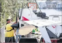  ?? AP PHOTO ?? The remains of an ICON A5 ultralight airplane are moved from a boat ramp in the Gulf Harbors neighborho­od of New Port Richey, Fla. on Wednesday.