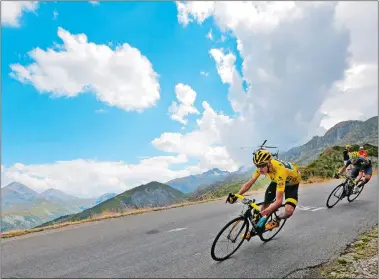  ?? CHRISTOPHE ENA/AP PHOTO ?? Britain’s Chris Froome, wearing the overall leader’s yellow jersey, and Spain’s Alejandro Valverde speed down Croix de Fer pass on Friday during the 19th stage of the Tour de France over 85.7 miles with start in Saint-Jean-de-Maurienne and finish in La...