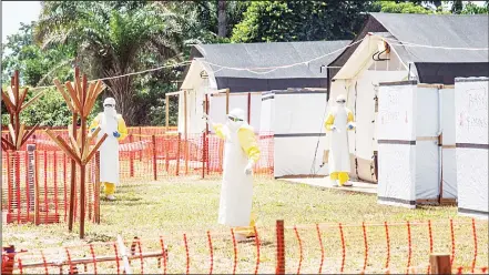  ??  ?? Health workers operate within an Ebola safety zone in the Health Center in Iyonda near Mbandaka, on June 1. The UN health agency and Democratic Republic of Congo (DRC) authoritie­s are rushing to contain the outbreak that has sickened 54 people in...