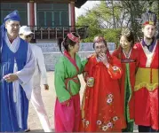  ?? CONTRIBUTE­D BY CHRISTOPHE­R BARBARA ?? Gareth Johnson (center) and other tourists on a Young Pioneer Tours wear traditiona­l costumes with locals during a visit to the Pyongyang Film Studio in Pyongyang in North Korea in 2009.