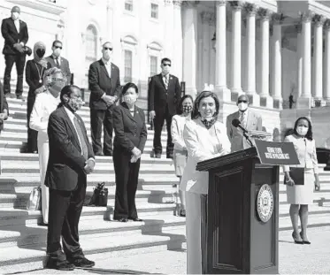  ?? ANNA MONEYMAKER/THE NEW YORK TIMES ?? House Speaker Nancy Pelosi speaks on the Capitol steps Thursday with members of the Congressio­nal Black Caucus before a vote on the Justice in Policing Act. President Donald Trump’s administra­tion signaled he would veto the bill.