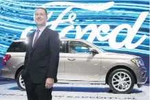  ?? MARK BLINCH, THE CANADIAN PRESS ?? Ford Canada president Mark Buzzell with a 2017 Ford Expedition.