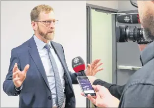  ?? GLEN WHIFFEN/THE TELEGRAM ?? Lawyer Jerome Kennedy, who is representi­ng the Campaign to Protect Accident Victims at the Public Utility Board public hearings, speaks to reporters during a break at the hearings in St. John’s Tuesday.