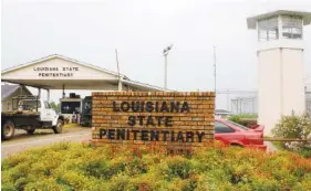  ?? AP FILE PHOTO/JUDI BOTTONI ?? Vehicles enter at the main security gate at the Louisiana State Penitentia­ry — the Angola Prison, the largest high-security prison in the country in Angola, La.