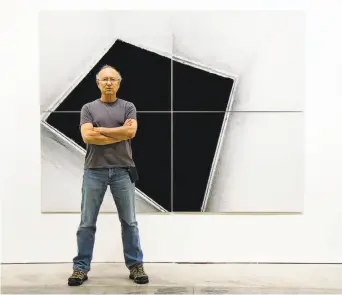  ?? Casemore Kirkeby ?? The late Oakland photograph­er Steve Kahn stands in front of one of his mural-size works at S.F.’s Casemore Kirkeby, which is exhibiting his collection titled “Corridors” through May 26.