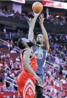  ??  ?? MICHAEL WYKE/AP Warriors forward Kevin Durant (R) puts up a shot over Rockets guard James Harden during an NBA meeting in Houston on January 20, 2018.