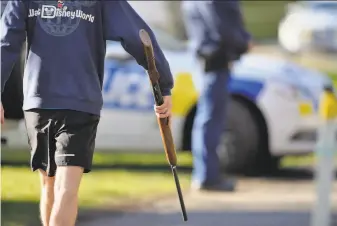  ?? Kai Schwoerer / Getty Images ?? A man hands in his firearms at Riccarton Racecourse in Christchur­ch, New Zealand, as part of the first gun buyback event after a terrorist attack on mosques in the city on March 15.