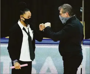  ?? David Butler II / USA Today ?? UConn coach Geno Auriemma, right, and South Carolina coach Dawn Staley meet before the start of a 2021 game at Gampel Pavilion.