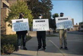  ?? PAT NABONG — CHICAGO SUN-TIMES VIA AP ?? Matt Muchowski, Vance Wyatt and Donald Blake hold signs with the names of Joseph Rosenbaum and Anthony Huber outside the Lake County Courthouse in Waukegan, Ill. during Kyle Rittenhous­e’s second extraditio­n hearing Friday morning.