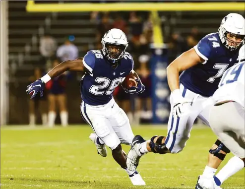  ?? UConn Athletics ?? UConn running back Nathan Carter carries against Middle Tennessee State on Oct. 22. Carter and grad student Robert Burns lead the Week 1 depth chart at running back.