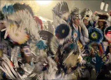  ?? RECORDER PHOTO BY ESTHER AVILA ?? Native Americans dressed in their finest ceremonial garments dance as they walk around a field Saturday at the Tule River 2021 Powwow.