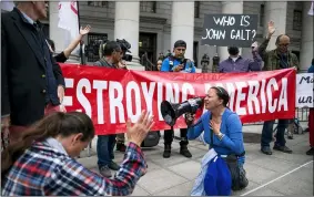  ?? AP PHOTO/EDUARDO MUNOZ ALVAREZ ?? People and teachers pray as they protest against COVID-19vaccine mandates outside the Manhattan Federal Court Tuesday, Oct. 12, 2021, in New York.