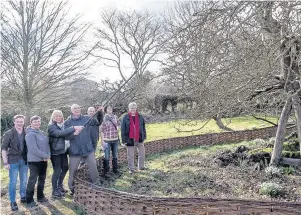  ??  ?? The ceremonial clipping of Newton’s Tree in Woolsthorp­e by Loughborou­gh University, in conjunctio­n with the National Trust.