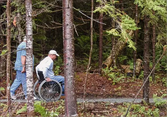  ?? Times Union archive ?? A specialize­d park in Long Lake to make the natural landscape of the Adirondack­s available to everyone, especially people with disabiliti­es, was a vision of John Dillon, Internatio­nal Paper’s retired chairman and CEO, who died earlier this month. Here, it is being used in 2006, the year it opened.