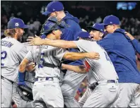  ?? AP PHOTO ?? The Los Angeles Dodgers celebrate after Game 3 of baseball’s National League Division Series against the Arizona Diamondbac­ks, Monday, in Phoenix. The Dodgers won 3-1 to advance to the National League Championsh­ip Series and will face the Chicago Cubs.