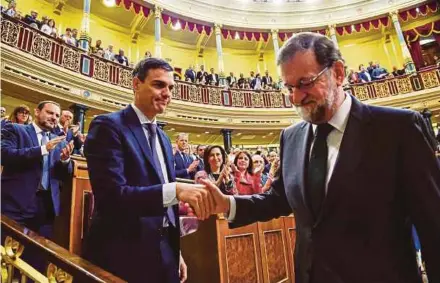  ?? REUTERS PIC ?? Spain’s new prime minister and Socialist party leader, Pedro Sanchez (left), shaking hands with ousted prime minister Mariano Rajoy after a no-confidence vote at Parliament in Madrid yesterday.