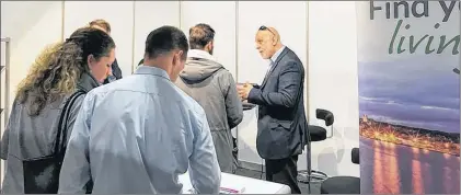  ?? PHOTO COURTESY OF DEPARTMENT OF ADVANCED EDUCATION, SKILLS AND LABOUR ?? Minister of Advanced Education, Skills and Labour Al Hawkins speaks with attendees at the Emigratieb­eurs Job Fair in Utrecht, Netherland­s, in February. The two-day event sees about 10,000 visitors a year from throughout the European Union.