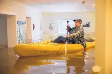  ?? SANTIAGO MEJIA/ASSOCIATED PRESS ?? Lorin Doeleman kayaks through her house in Guernevill­e, Calif., Wednesday to check on damage caused by a series of storms that hammered the Northwest.