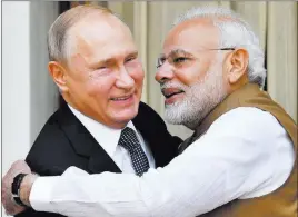  ?? Yuri Kadobnov ?? The Associated Press Indian Prime Minister Narendra Modi hugs Russian President Vladimir Putin before their meeting Friday in New Delhi.