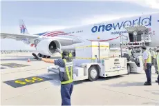  ?? — Bernama photo ?? The first batch of the Pfizer-BioNTech Covid-19 vaccines are seen being unloaded from the cargo section of an aircra at the Kuala Lumpur Internatio­nal Airport. Malaysia’s economy is expected to return to positive growth this year, along with other economies globally on the sustained progress in the vaccine rollouts that will boost consumptio­n worldwide, the World Bank says.