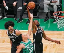  ?? Mary Schwalm / Associated Press ?? Nets forward Kevin Durant (7) pulls down a rebound during the second half of a preseason game against the Celtics. Durant finished with 25 points.