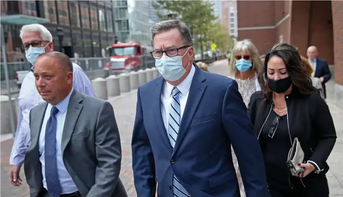  ?? MATT sTONE / hErALd sTAFF ?? ‘THAT IMPACTS ALL OF US’: Former state Rep. David Nangle, center, leaves federal court in the Seaport after being sentenced Wednesday to 15 months in federal prison on corruption charges.