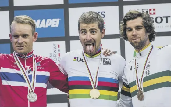  ??  ?? 2 Peter Sagan, the first man to win three consecutiv­e world titles, is flanked by silver medallist Alexander Kristoff, left, and Michael Matthews, who took bronze.