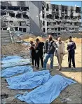  ?? ?? Bodies...mass grave is found by Shifa Hospital, Gaza City