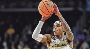  ?? JUNFU HAN/DETROIT FREE PRESS ?? Michigan guard Dug McDaniel makes a pass against Toledo during the first half of the first round of the NIT at Crisler Center on Tuesday in Ann Arbor.