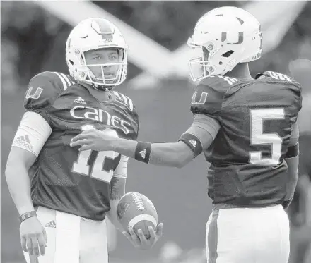  ?? WILFREDO LEE/AP ?? Miami quarterbac­ks Malik Rosier and N'Kosi Perry, seen here at a practice earlier this season, both saw action early in the Hurricanes' game against Duke.