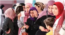  ?? AFP ?? Lebanese women line up to vote for the parliament­ary election on May 15.