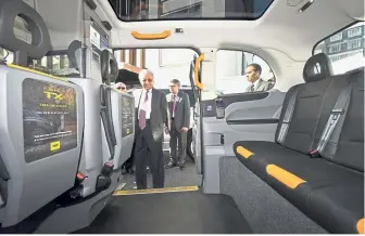  ??  ?? Slick transport: Dr Mahathir inspecting the new London electric taxi owned by Geely. — Bernama