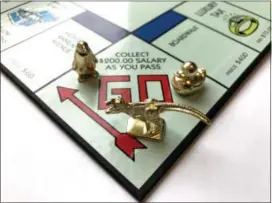  ?? MARVIN JOSEPH — THE WASHINGTON POST ?? Fans of the game Monopoly voted to replace three of the eight tokens in 2017. The new tokens are, from left, a penguin, a T. rex and a duck. Beginning in August, new games will feature the pieces, which will be silver-colored to match the others.