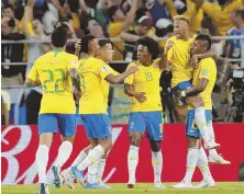  ?? AP PHOTO ?? LET’S GET IT STARTED: Neymar leaps into the arms of goal-scorer Paulinho (far right) after opening the scoring in Brazil’s win over Serbia yesterday in Moscow.