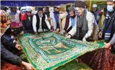  ?? ?? Vice-chairman of national commission for minorities Atif Rasheed with others offers special prayers at Hazrat Nizamuddin Dargah for Prime Minister Narendra Modi to grant him good health and long life in New Delhi on Friday.