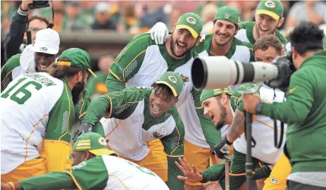  ?? WM. GLASHEEN / USA TODAY NETWORK-WISCONSIN ?? Packers receiver Jake Kumerow is welcomed home after a hitting home run during the Green & Gold Charity Softball Game on June 1 at Fox Cities Stadium in Grand Chute.