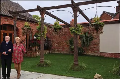  ??  ?? Battling the planners: The Very Rev Peter Berry and his sister Georgina Key in front of the pergola